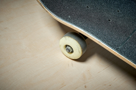black used skateboard on a light wooden backgroundの写真素材