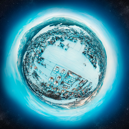 Winter little planet with a small village covered with snow in high mountainsの写真素材