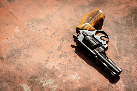 Black 9mm revolver on the concrete red backgrooundの写真素材