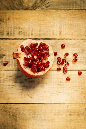 fresh pomegranate fruit on an old wooden tableの写真素材