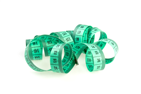 isolated green measuring tape on a white backgroundの写真素材