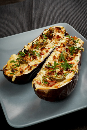 delicious casserole of aubergine cheese and jalapeno peppers on a gray plateの写真素材