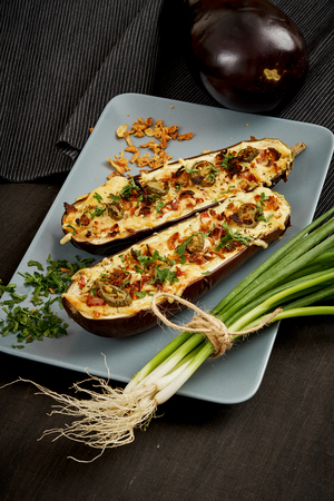 delicious casserole of aubergine cheese and jalapeno peppers on a gray plateの写真素材