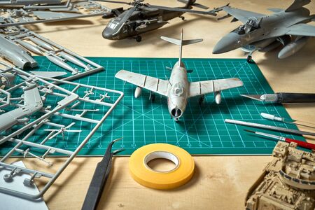 Top view on plastic model scale with accessories on  green pad on  wooden tableの写真素材