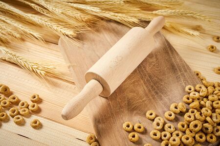 delicious crunchy breakfast on a wooden table with rye ears and a rolling pinの写真素材