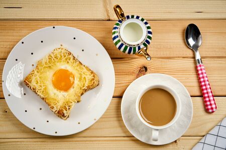 breakfast set with coffee and toast with egg on wooden tableの写真素材