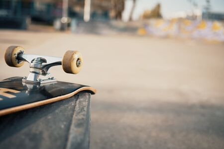 Close up of skateboard wheels in concrete skatepark on warm dayの写真素材
