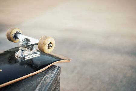Close up of skateboard wheels in concrete skatepark on warm dayの写真素材