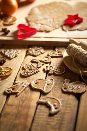 Dough for Christmas gingerbread and cookie cutters on wooden tableの写真素材