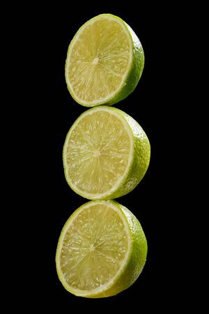 Green three fresh organic kiwi halves on black backgroundの写真素材