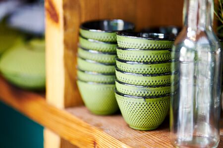 Closeup of bowls on wooden shelf in restaurant prepared for servingの写真素材