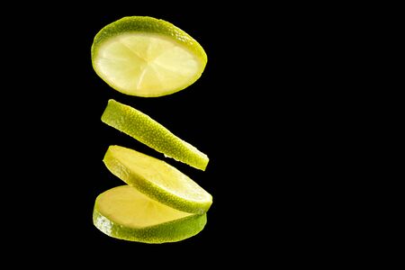 Green fresh organic kiwi four slices on black backgroundの写真素材