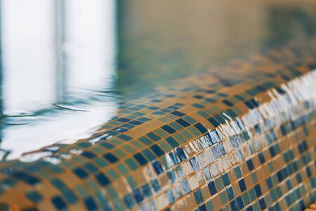 Closeup of wet mosaic in the pool of luxury hotelの写真素材