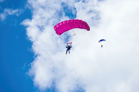 brave man flies on a parachute at the summer air showの写真素材
