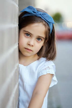 cute girl pose on the city street at sunsetの写真素材