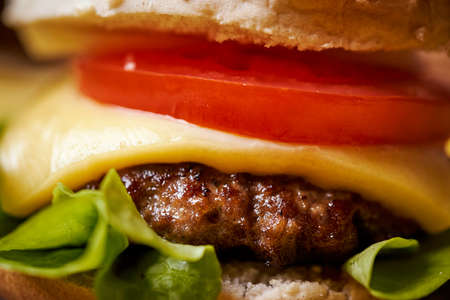 delicious cheeseburger on a black table with salt crystalsの写真素材