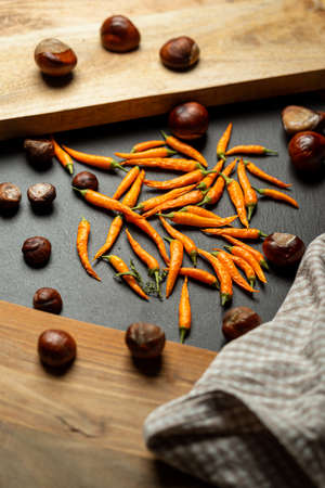 Hot yellow chili or chilli pepper on stone table.の写真素材