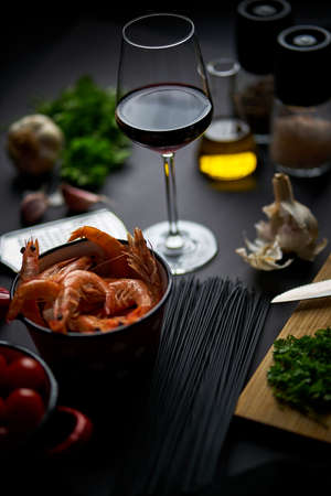 black shrimp table with wine noodles and spicesの写真素材
