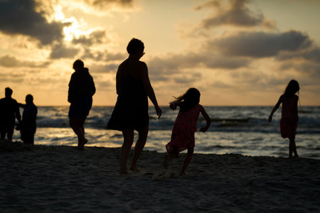 Family vacation sunset happy together at the beachの写真素材