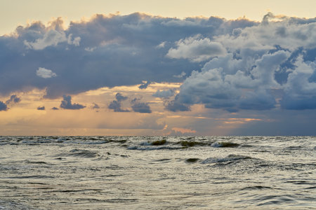 Epic dark sunset sky above the sea shore after the storm.の写真素材
