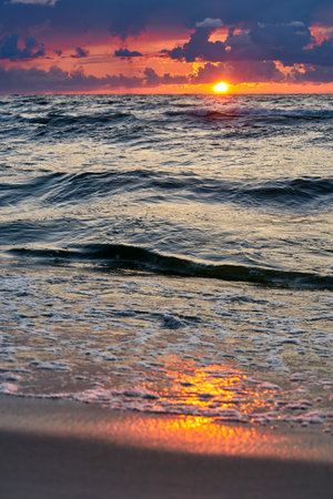 Epic dark sunset sky above the sea shore after the storm.の写真素材