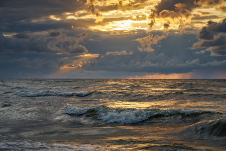 Epic dark sunset sky above the sea shore after the storm.の写真素材