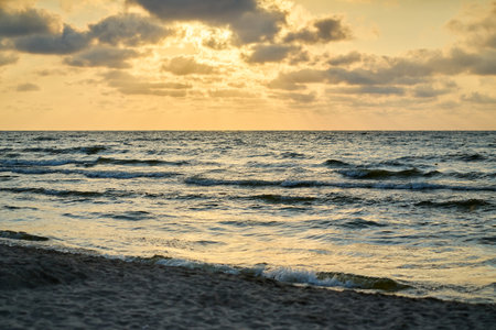 Epic dark sunset sky above the sea shore after the storm.の写真素材
