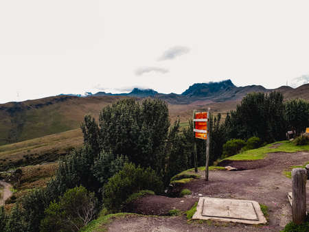 A vertical shot of a signpost with a mountain in the backgroundの写真素材