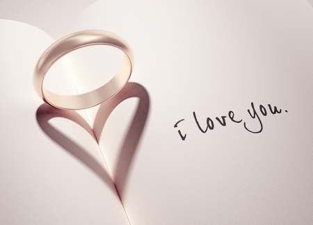 heartshadow with rings on a book middle - i love you - cardの写真素材
