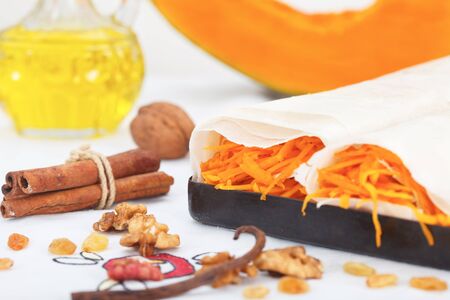 Making sweet pumpkin roll pie with walnuts and cinnamonの写真素材