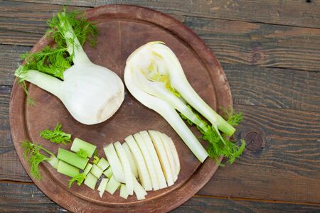 Raw Organic Fennel Bulbs on wooden board ready to cook, top viewの写真素材