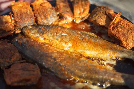 Trout fish frying in oil on the fire.の写真素材