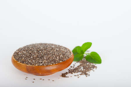 Healthy chia seeds (lat. Salvia hispanica) in wooden bowl. Vegan diet conceptの写真素材