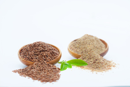 Flax seeds and grinded  linseed in wooden bowls. Healthy food for preventing heart diseases and overweight.の写真素材