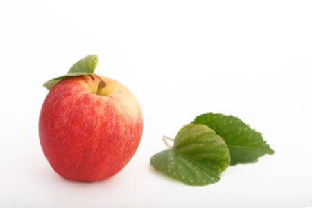 Fresh, red apple with leaves on white background. Organic apple, sweet and healthy fruit.