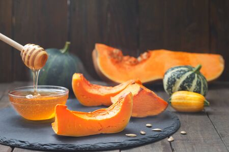 Baked butternut squash with honey. Roasted sweet pumpkin slices. Healthy vegetarian food.の写真素材