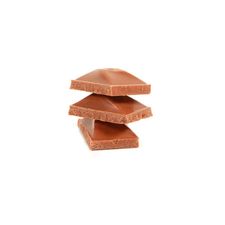 Pieces of chocolate on top of each other on a white background