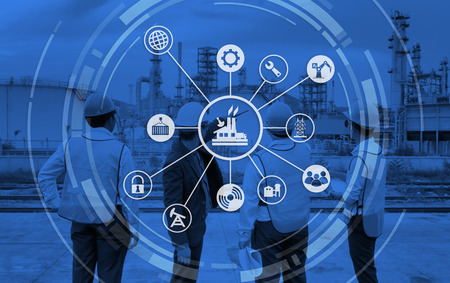 The engineer discussing a new project with large industry background with industrial instruments in...