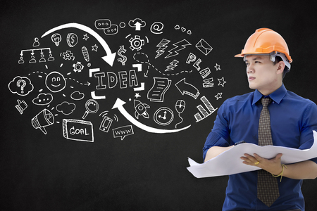Engineer man is think for creative idea on isolated black chalkboard background. Decision making process concept.の写真素材