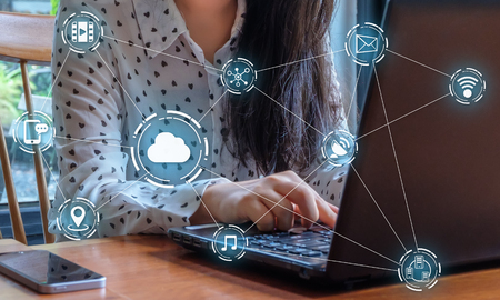 Hand of businesswoman using using laptop in office and cloud technology icon network.の写真素材