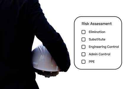 Hazard Identification and Risk Assessment concept (Safety work place) - Engineering man or Safety Inspector standing with risk assessment checklist.の写真素材