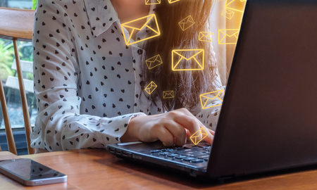 Business woman use tablet with email icons in work space. Email concept background.の写真素材