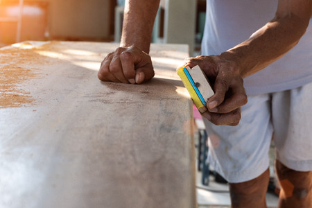 Carpenter is working in his workshop. Carpenter make the door from big wood.の写真素材