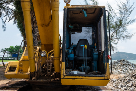 Seat controller of yellow excavator.