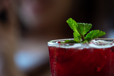 Fresh red juices, sweet and sour taste, placed on a blurred background.