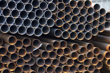 Metal profile pipe of round section in packs at the warehouse of metal products, Russia