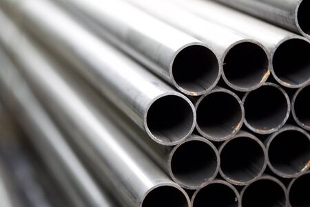 Metal profile pipe of round section in packs at the warehouse of metal products, Russiaの写真素材