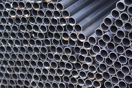 Metal profile pipe of round section in packs at the warehouse of metal products, Russia