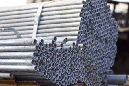 Metal profile pipe of round section in packs at the warehouse of metal products, Russia