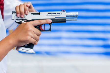 A woman holding a gun in hand the ship ready to shoot IPSC competition pistol games